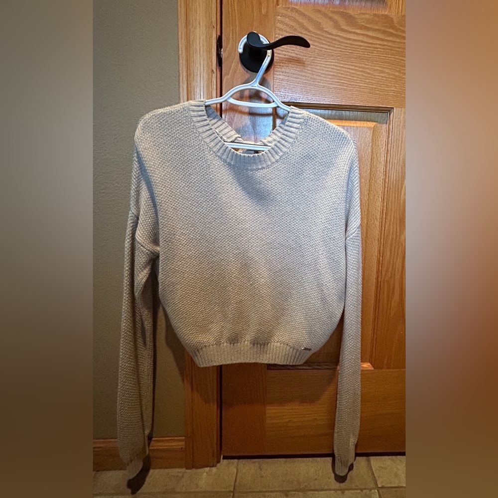 Hollister tan, crop sweater, with open back and tie.  Size Small.